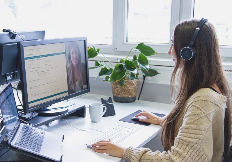 Woman sitting in front of a computer using the self-service portal